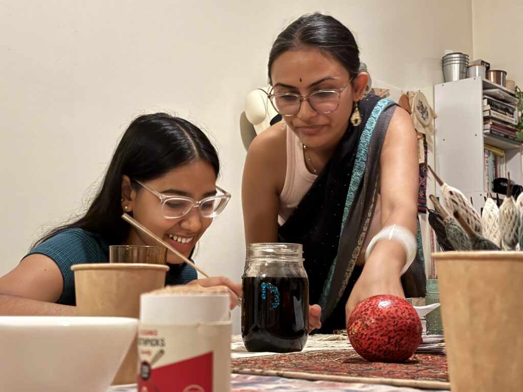 Shah with student in studio workshop. (Photo courtesy of Nikita Shah.)