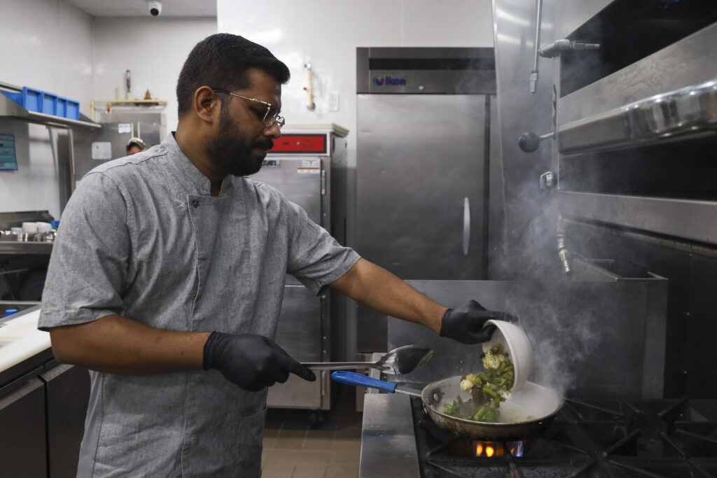 Anand Vihar’s Executive Chef, Sunny Grewal, cooks vegetables for residents’ dinner. Grewal plans each dinner based on the number of residents signed up for the meal. July 16, 2025.