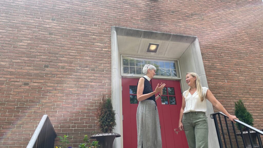 Rev. Maria Tjeltveit and Jessica Entwistle chat outside the Church of the Mediator in Allentown, Pennsylvania. (Photo by Kabir Burman.)