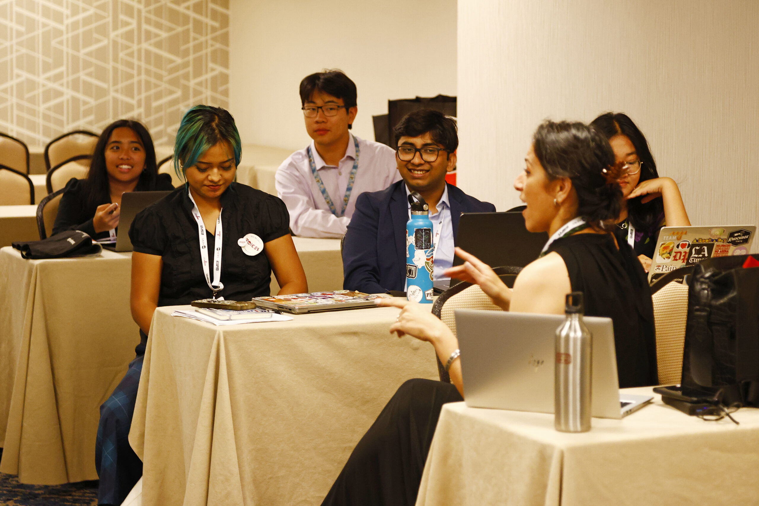 Photo of Voices fellow standing against AAJA backdrop onstage